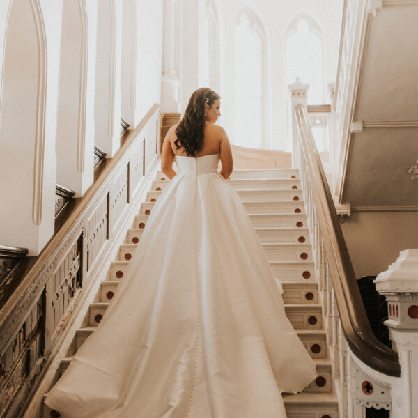 bride walking up historic venue stairwell