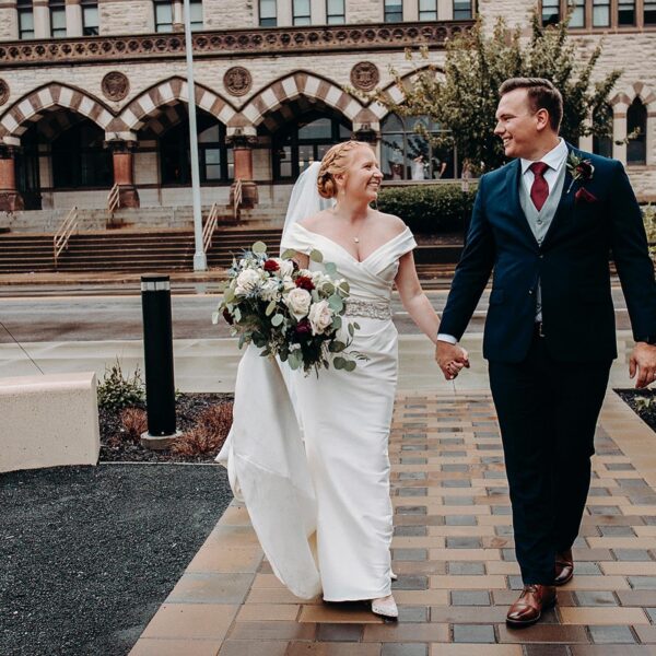 bride and groom walking and holding hands