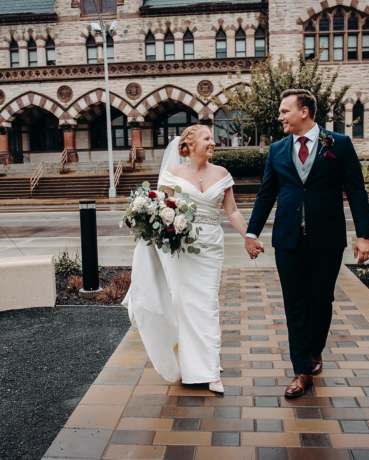 bride and groom walking and holding hands