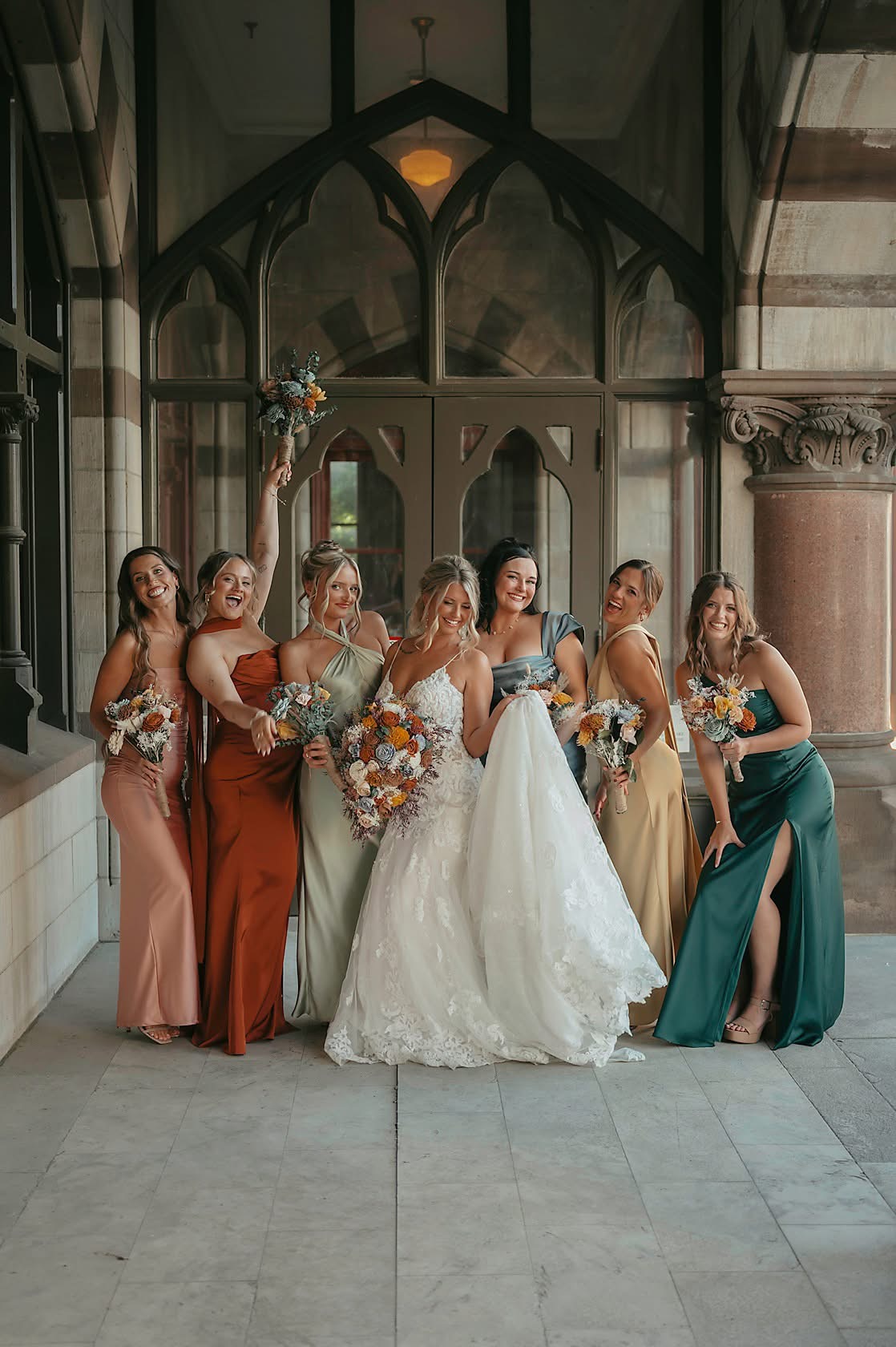 bride and bridesmaids in mismatched gowns